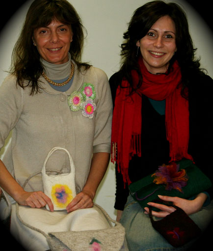 Laura Gandolfi with friend showing handbags